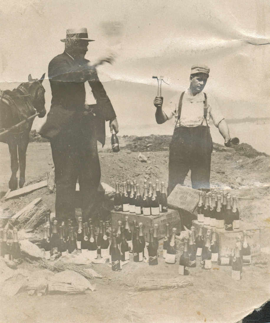  Ed Regenhardt (left) destroying bottles of champaign 